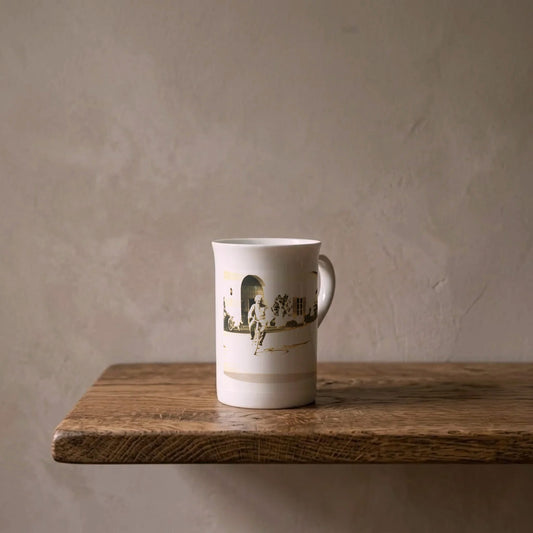 Albert Einstein on a Bicycle, 1933 – porcelain art mug on an oiled oak shelf against a limewashed wall