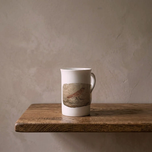 Egyptian Ostracon: Sketch of a Sparrow, c. 1470 BCE – porcelain art mug on an oiled oak shelf against a limewashed wall