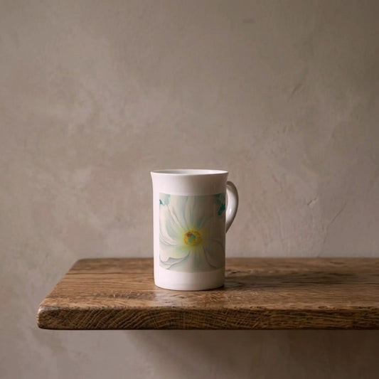 Georgia O'Keeffe: White Flower, 1929 – porcelain art mug on an oiled oak shelf against a limewashed wall
