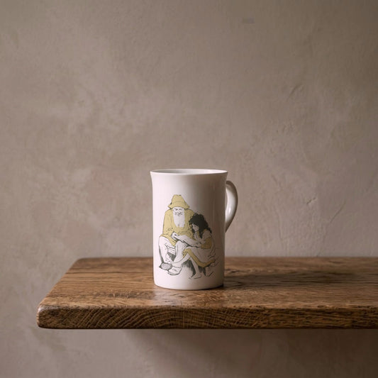 Heidi and Grandfather – porcelain art mug on an oiled oak shelf against a limewashed wall