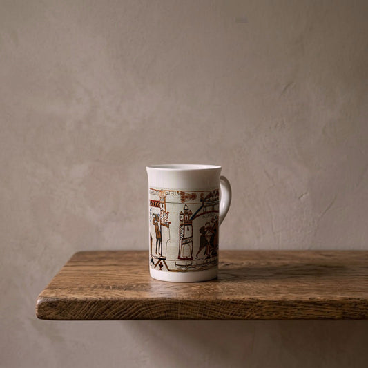 Bayeux Tapestry comet scene on a porcelain art mug on an oak shelf