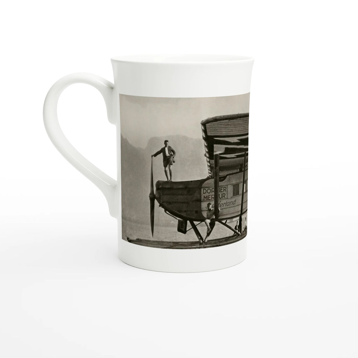 Porcelain mug seen from the left, handle on the left, showing the nose of the aircraft and a man standing on it