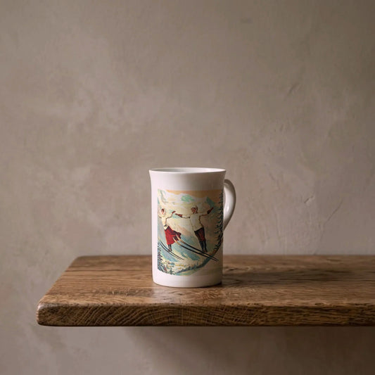 Francisco Tamagno: Chamonix Ski Jumpers, 1900 – porcelain art mug on an oiled oak shelf against a limewashed wall