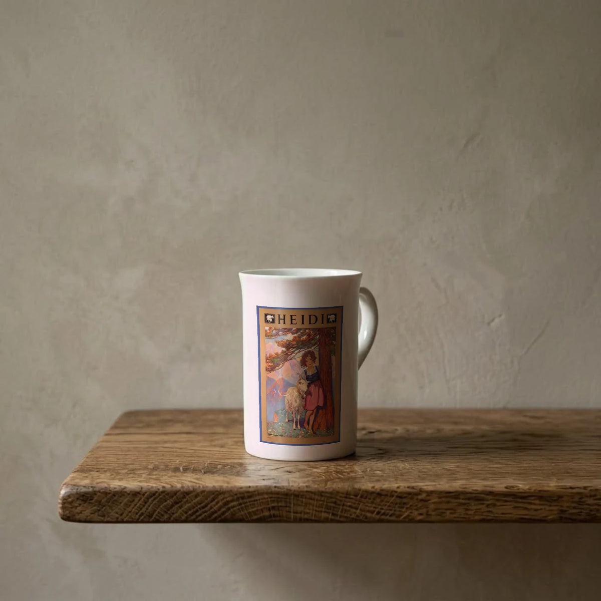 Heidi, 1922 cover – porcelain art mug on an oiled oak shelf against a limewashed wall