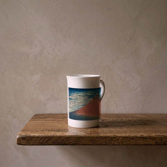 Katsushika Hokusai: Red Fuji, c. 1831 – porcelain art mug on an oiled oak shelf against a limewashed wall