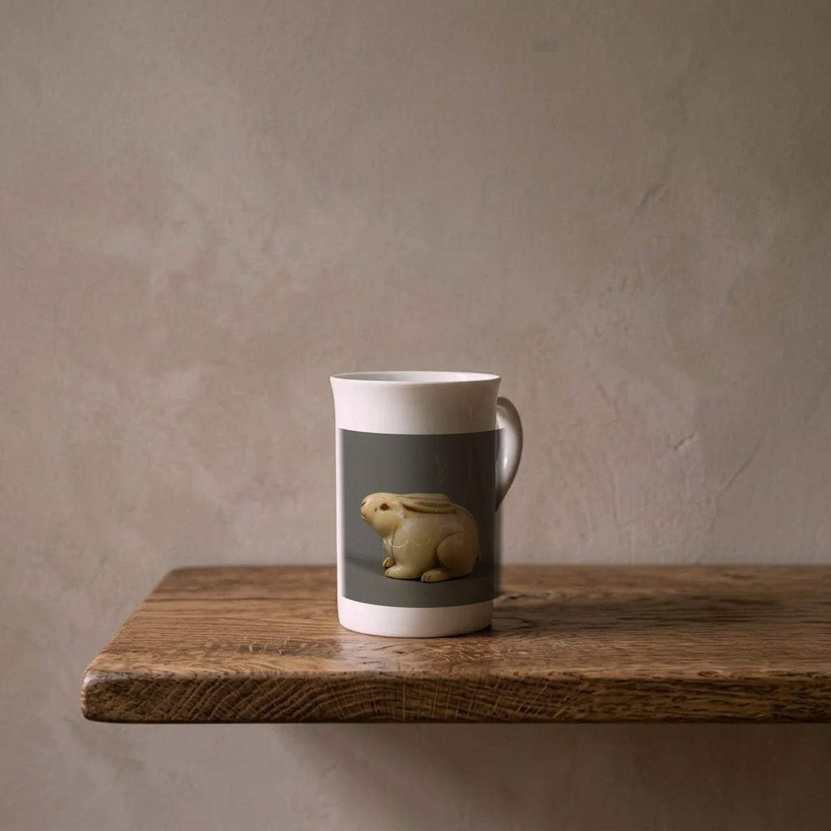 Netsuke: Hare with Amber Eyes, Edo Period – porcelain art mug on an oiled oak shelf against a limewashed wall