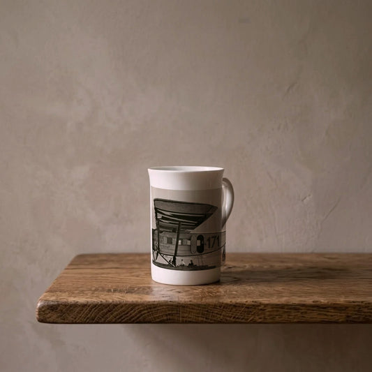 The ‘Switzerland’ porcelain art mug standing on an oiled oak shelf against a limewashed wall