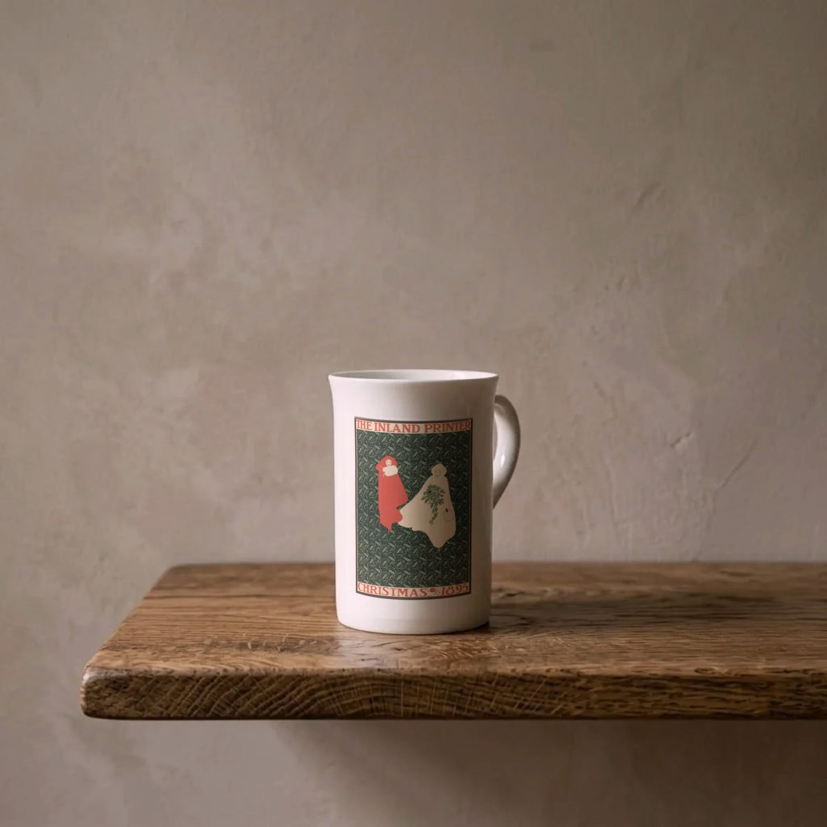 William H. Bradley: Christmas 1895 – porcelain art mug on an oiled oak shelf against a limewashed wall